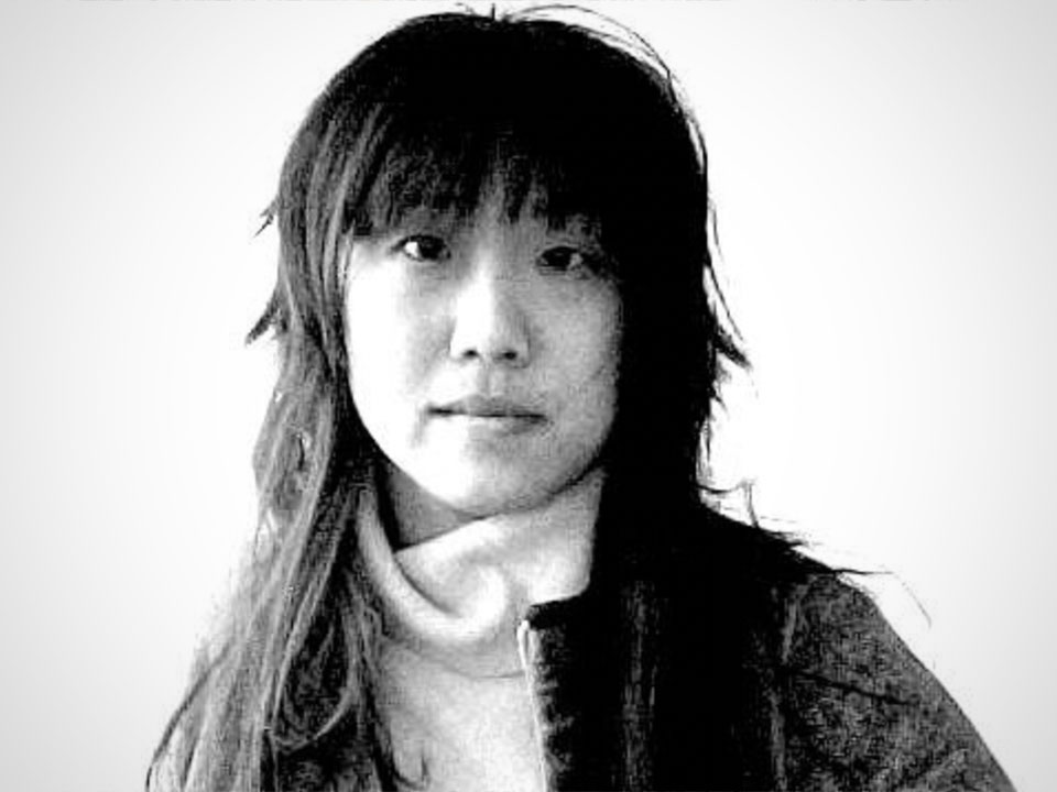 A black and white slightly pixelated image of a woman with dark hair against a pure white background
